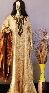 a mannequing of a woman in a gold dress