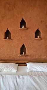 Rustic mudstone wall room with sit-out deck in Ilika Resorts