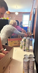 a man is standing in a box of cans of soda