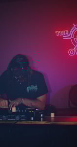 a man in a black shirt is playing a dj - creechur