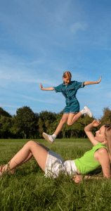 a woman and a child playing with a frisbee