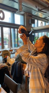 a woman taking a picture of herself in a restaurant