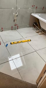 bathroom flooor tiling by axm plumbing