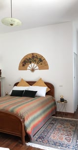 spot of bedroom at the azalea apartment at villa ombrosa