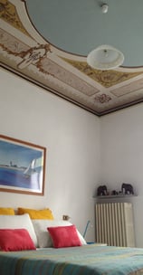 spot of main bedroom with painted ceiling at the ortensia apartment at villa ombrosa