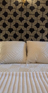 a bed with a white bed and a lamp