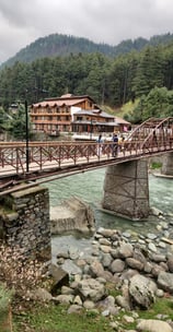 A 5 star Hotel with a bridge with a bridge over a river