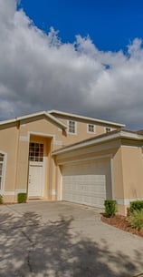 a Florida villa home with a palm tree