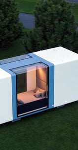 Futuristic tiny home pod with glass walls in green space