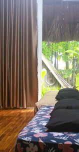 Spacious twin-bed room with large windows overlooking the tropical vegetable garden.