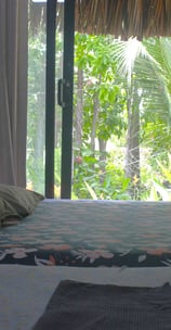 Bright garden-view room with two separate beds and air conditioning, ideal for comfort seekers.