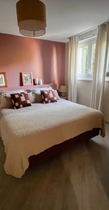 a bedroom with a bed and a wooden cabinet