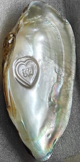 "Side-angle view of 10mm white heart-shaped cultured pearl–nucleus-based designer piece-for overseas demand"