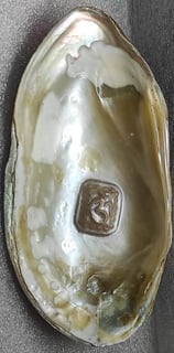 "Approx 11mm white cultured pearl featuring engraved Om symbol–using nucleus implantation-Prepared for export"