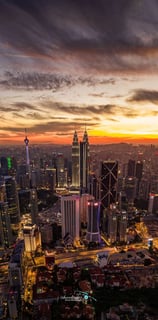 a cityscape of a city at sunset