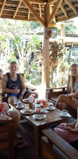 a group of people sitting around a table enjoying breakfast at sunrise lodge and lounge