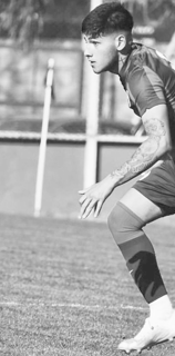 a man in a uniform playing soccer