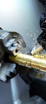 a machine is turning a hole in a machine shop