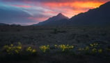 a sunset sky with a mountain in the background. arbab naimat kasi balochistan