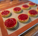 a baking tray with a tray of food and a cookie
