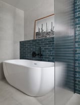 deep, glossy teal metro tiles, laid in a horizontal stack with white grout and fluted shower screen