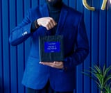 a man in a blue suit and a black suit