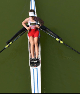 a woman rowing a boat on a lake
