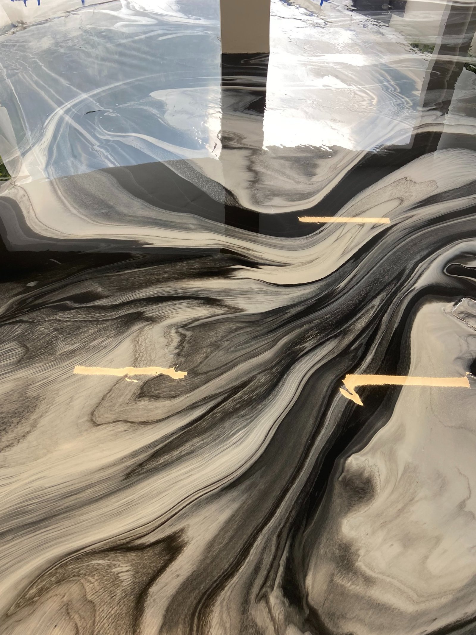 Metallic epoxy swirl pattern on garage floor