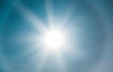 brilliant sun in blue sky