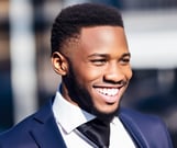 a man in a suit and tie smiling