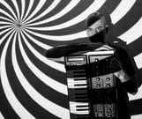 a man with a beard and a beard, holding a piano and a keyboard
