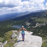 Martina with open arms in the mountains. Seven Rila Lakes.