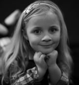 A young girl smiling and posing for the camera