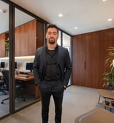 a man in a suit and tie standing in a room