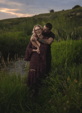 a man and woman standing in a field for a photoshoot in Calgary 