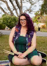 Self portrait, purple hair, smiling, green dress, purple vest