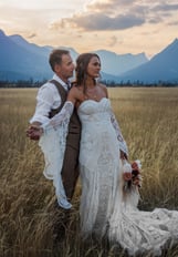 a bride and groom standing in a field in Jasper