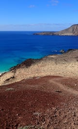 a woman walking up a volcano