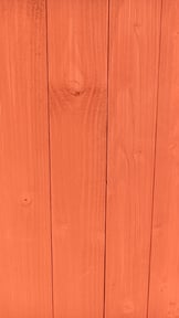 Tust red newly painted on wood barn paint