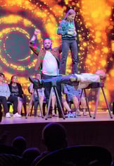 a man standing on a stage with a woman on stage