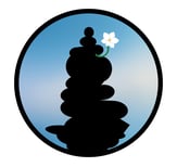 unanomalize podcast brand icon in a black circle with blue sky, black stacked stone cairn, white orchid growing out of cairn