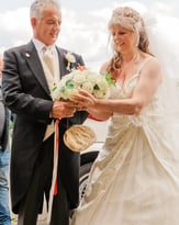 Couple With Their Bouquet Of Flowers