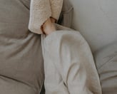 woman lying in pajamas and house shoes