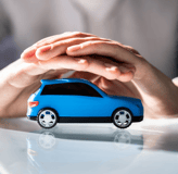 a person holding a toy car in their hands
