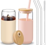 a glass jar with a straw and a strawberries in it