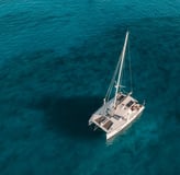 a sailboat in the ocean with a sailboat in the water