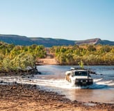 a vehicle driving through a river with a vehicle driving through the water