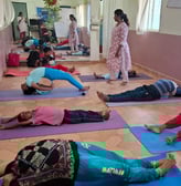 a group of people doing yoga exercises on a mat