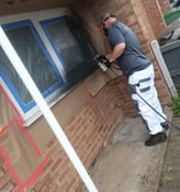 Mr Spray technician applying UPVC spray paint to ground floor windows in Worcester