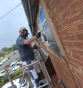UPVC window spraying in progress on upper floor of Worcester home using scaffold tower
